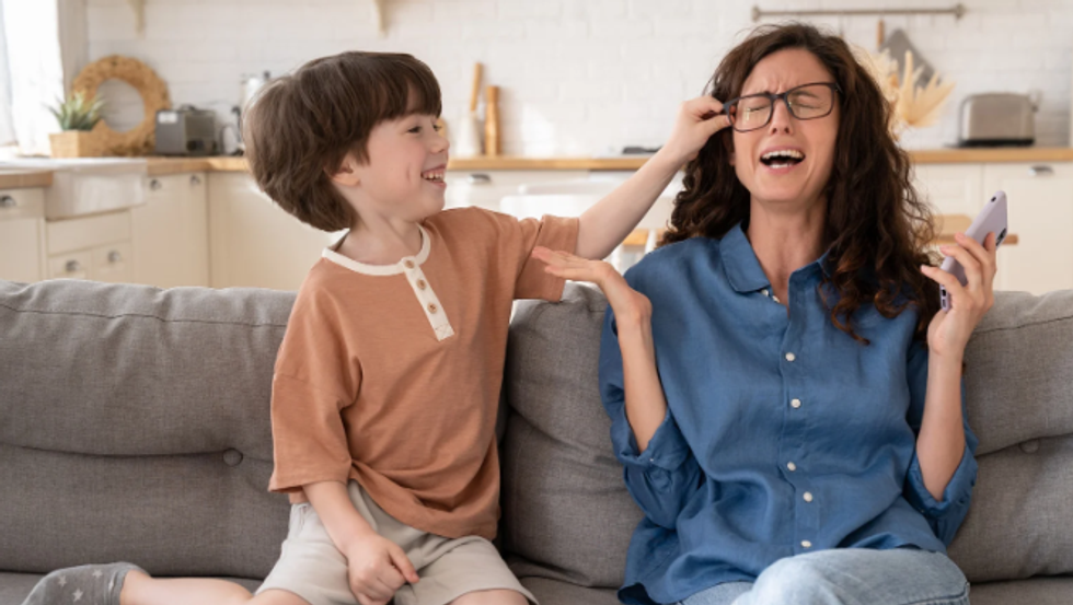 mom and son, playful child, stressed mom, woman with glasses, family on couch,