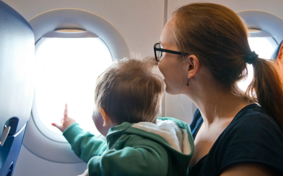toddler on plane, airplane, plane window, mom and toddler, curious child, airplane seats