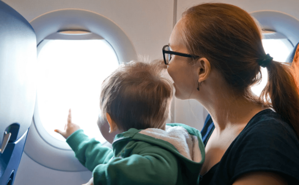 toddler on plane, airplane, plane window, mom and toddler, curious child, airplane seats