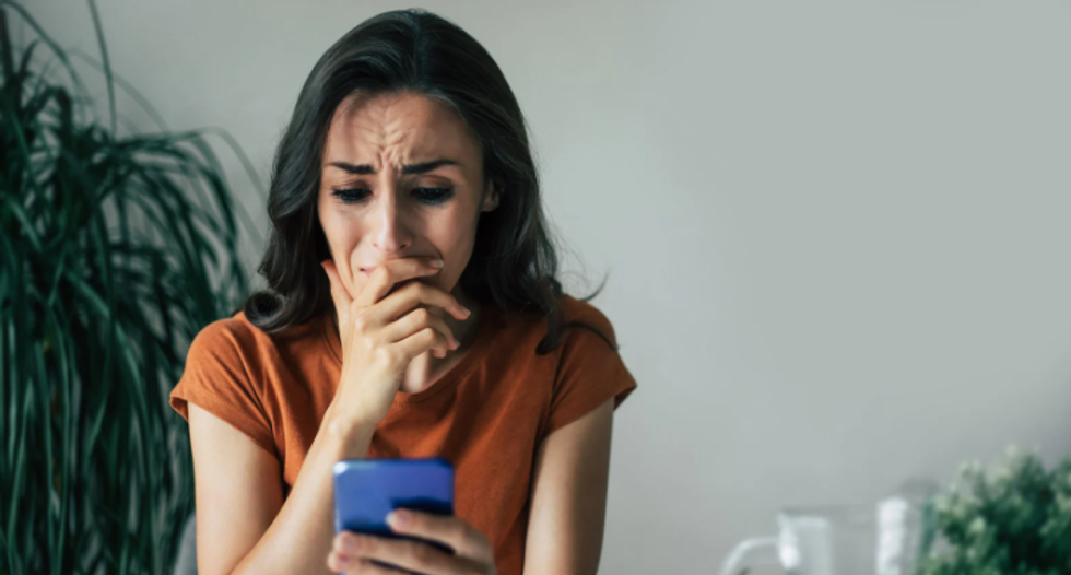 sad woman, upset woman, woman looking at phone, shocked woman, mad woman