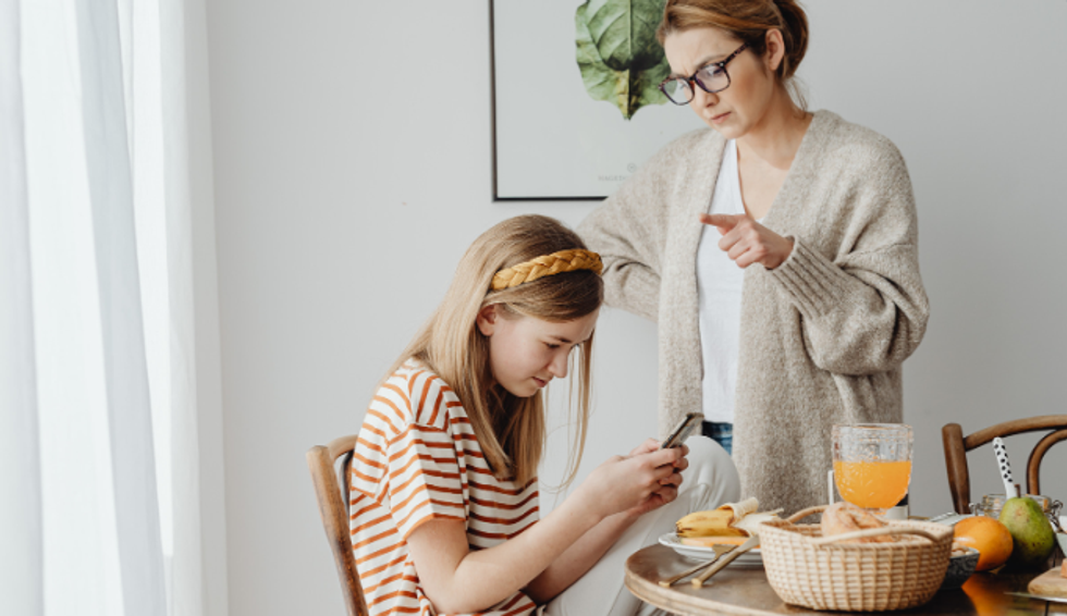 teens, social media, teen on phone, parents, upset mom, teen at table,