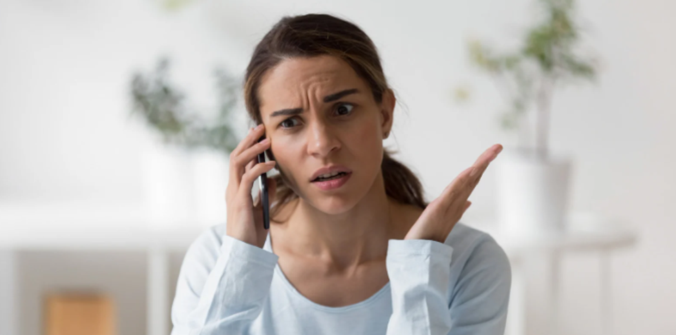 woman on phone, upset woman, confused woman, woman white top, smartphone, brown hair