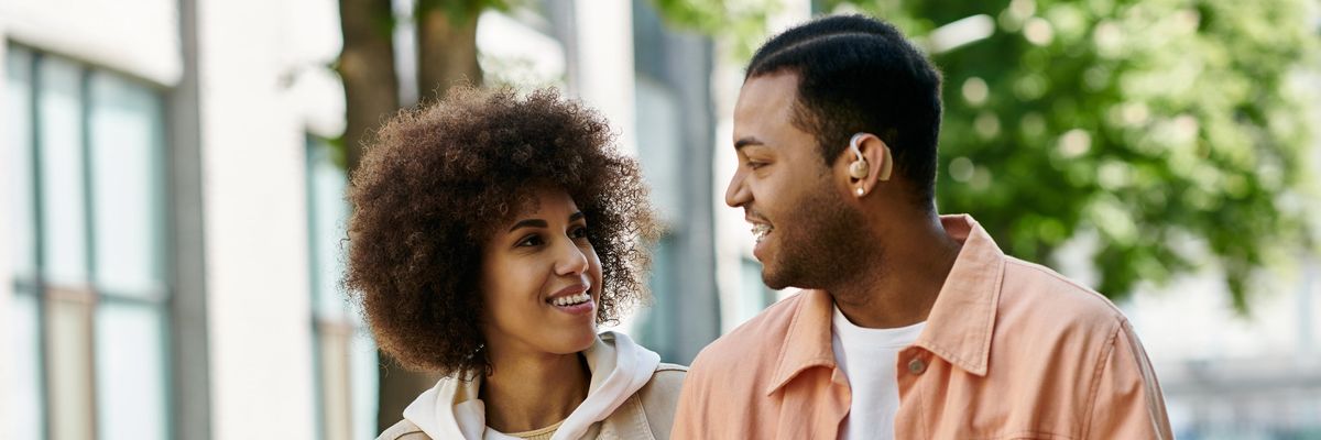 Two friends walking close and laughing, hinting at possible romantic chemistry