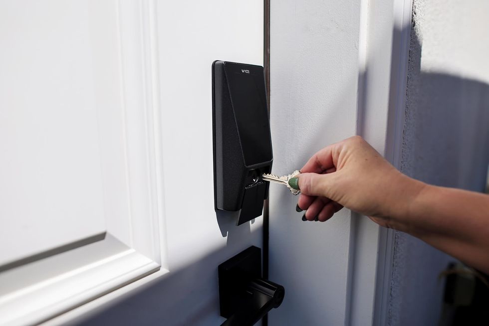 a person inserting a key into Wyze Palm Lock