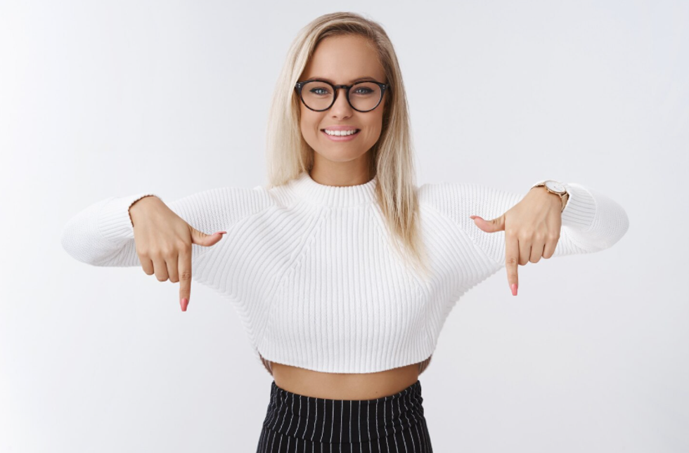 a photo of a woman pointing downward