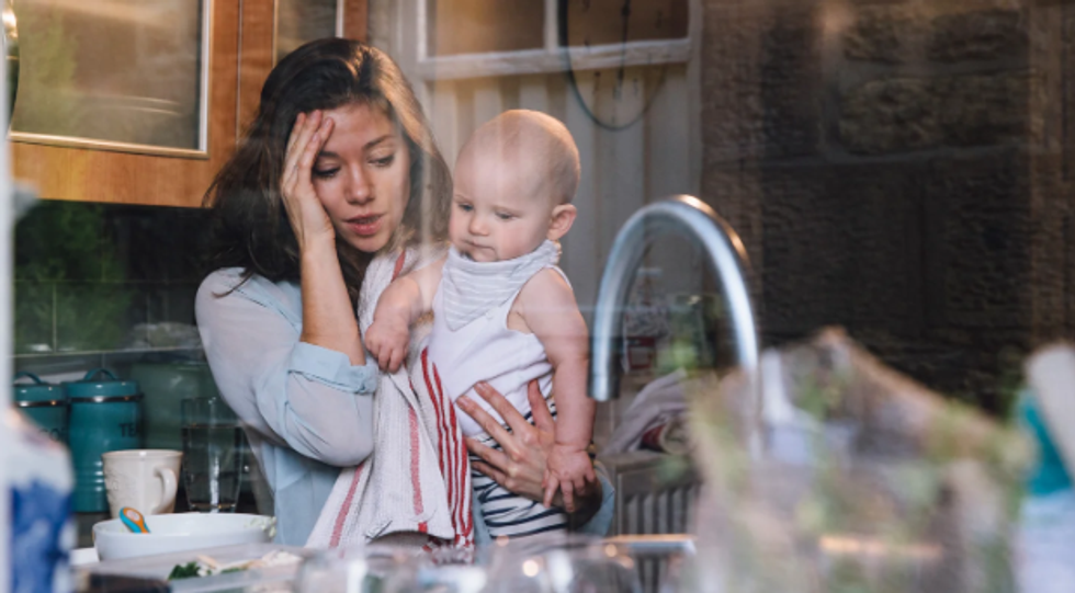 stressed mom, mom in kitchen, mom with baby, stress, agony, sad mom