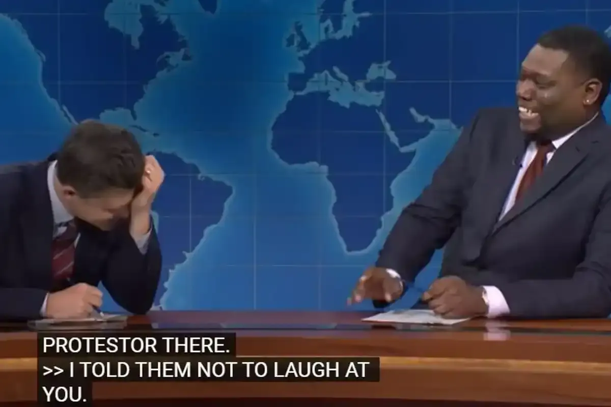 Colin Jost and Michael Che laughing on Weekend Update
