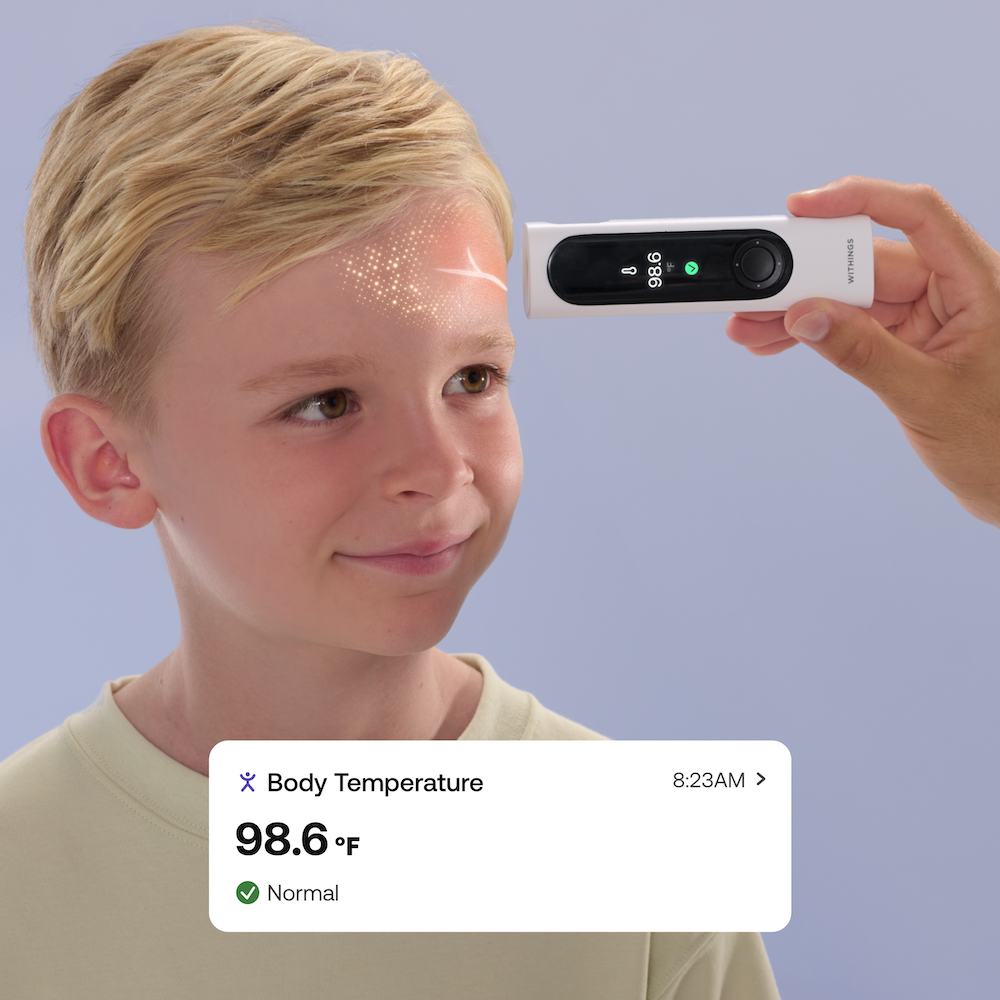 photo of a small boy gettiing his temperature reading by BeamO