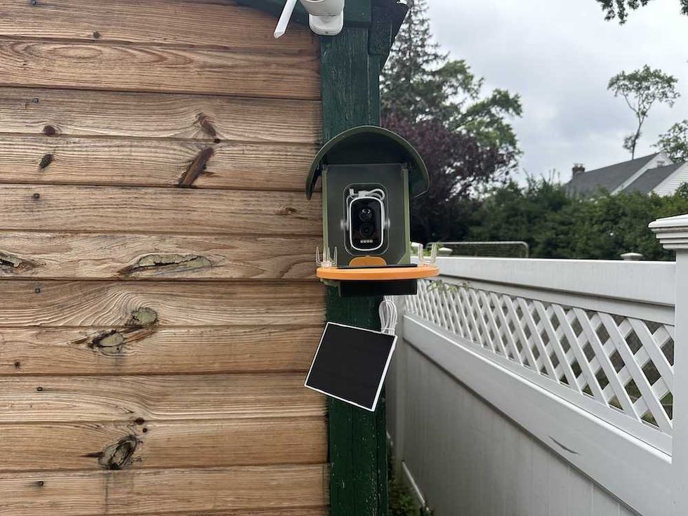 a photo of Vinguys Smart Bird Feeder on shed before it starts to rain.