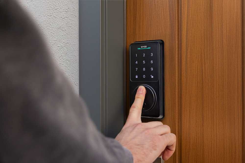 photo of a man using their finger to lock Wyze Lock Bolt v2