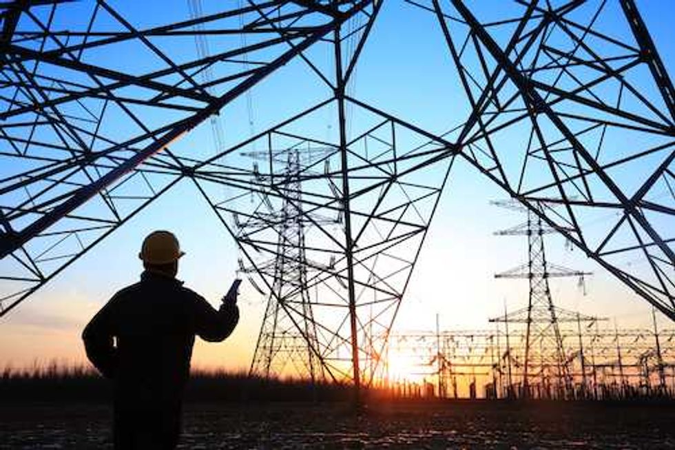 electricity workers and pylon silhouette photo