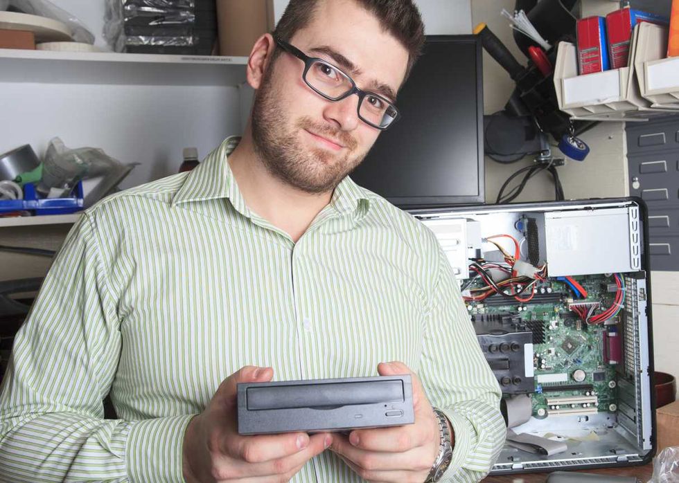 a electronics engineer holding a dvd player