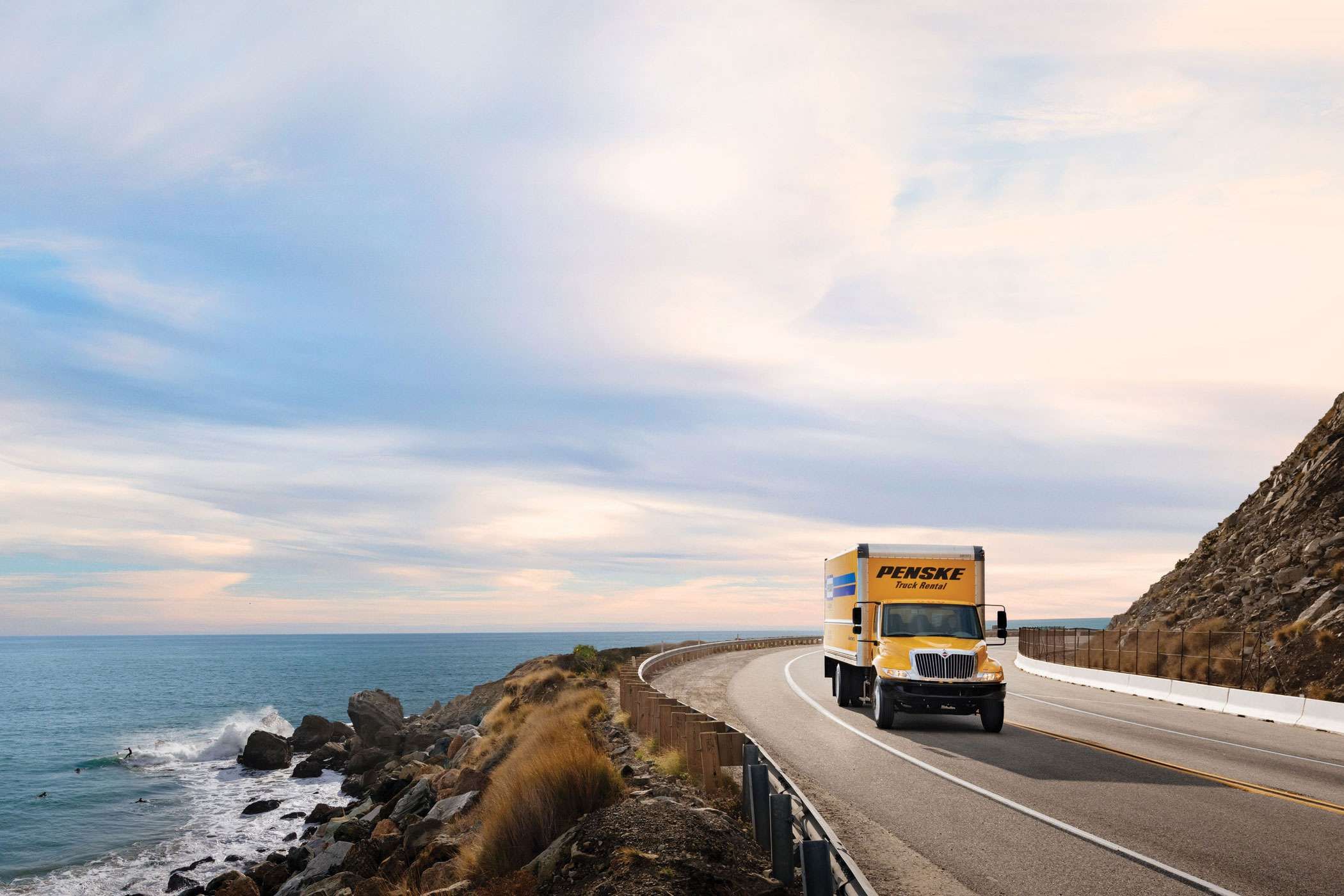 Penske truck driving along the ocean