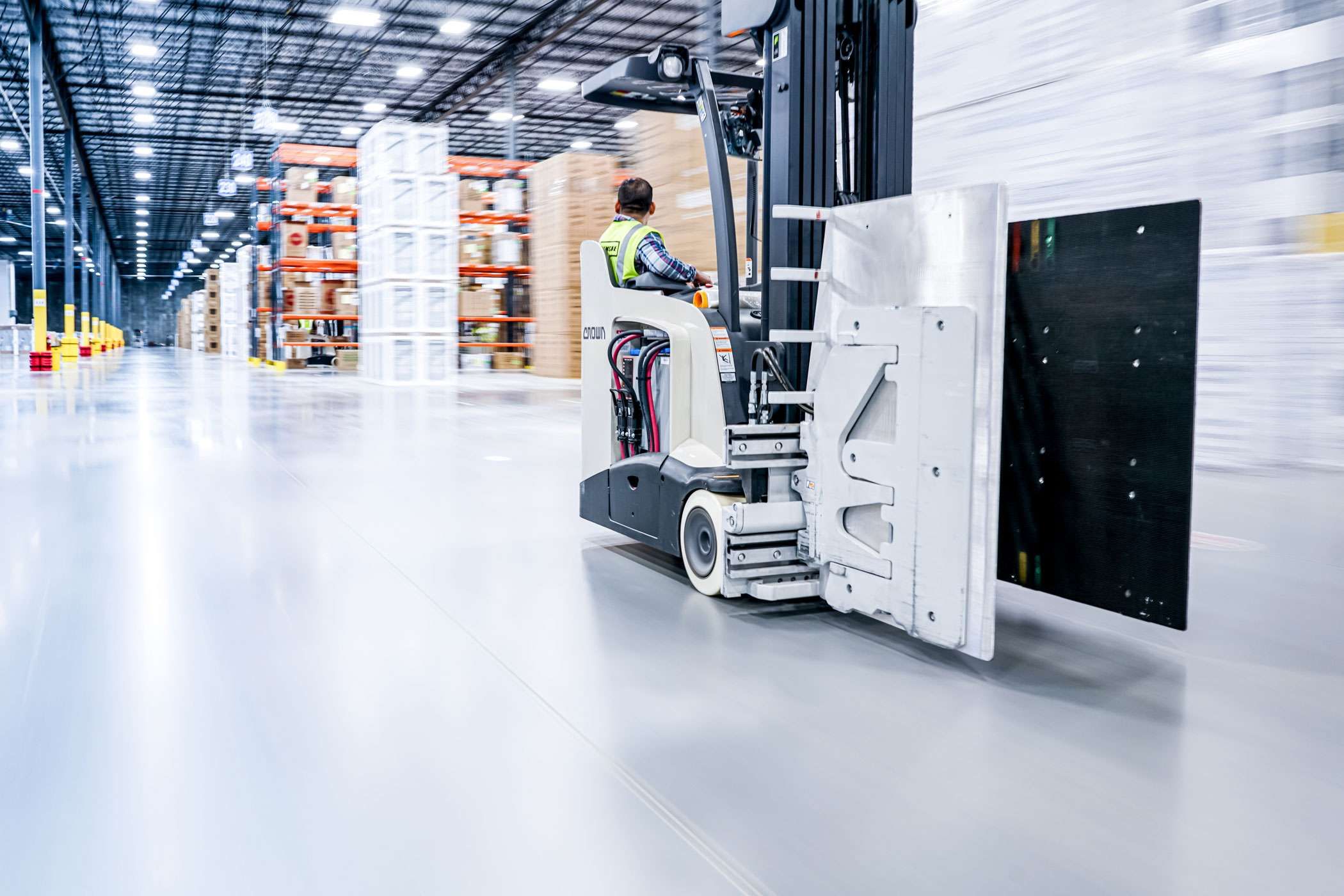 Penske warehouse employee using a modern forklift