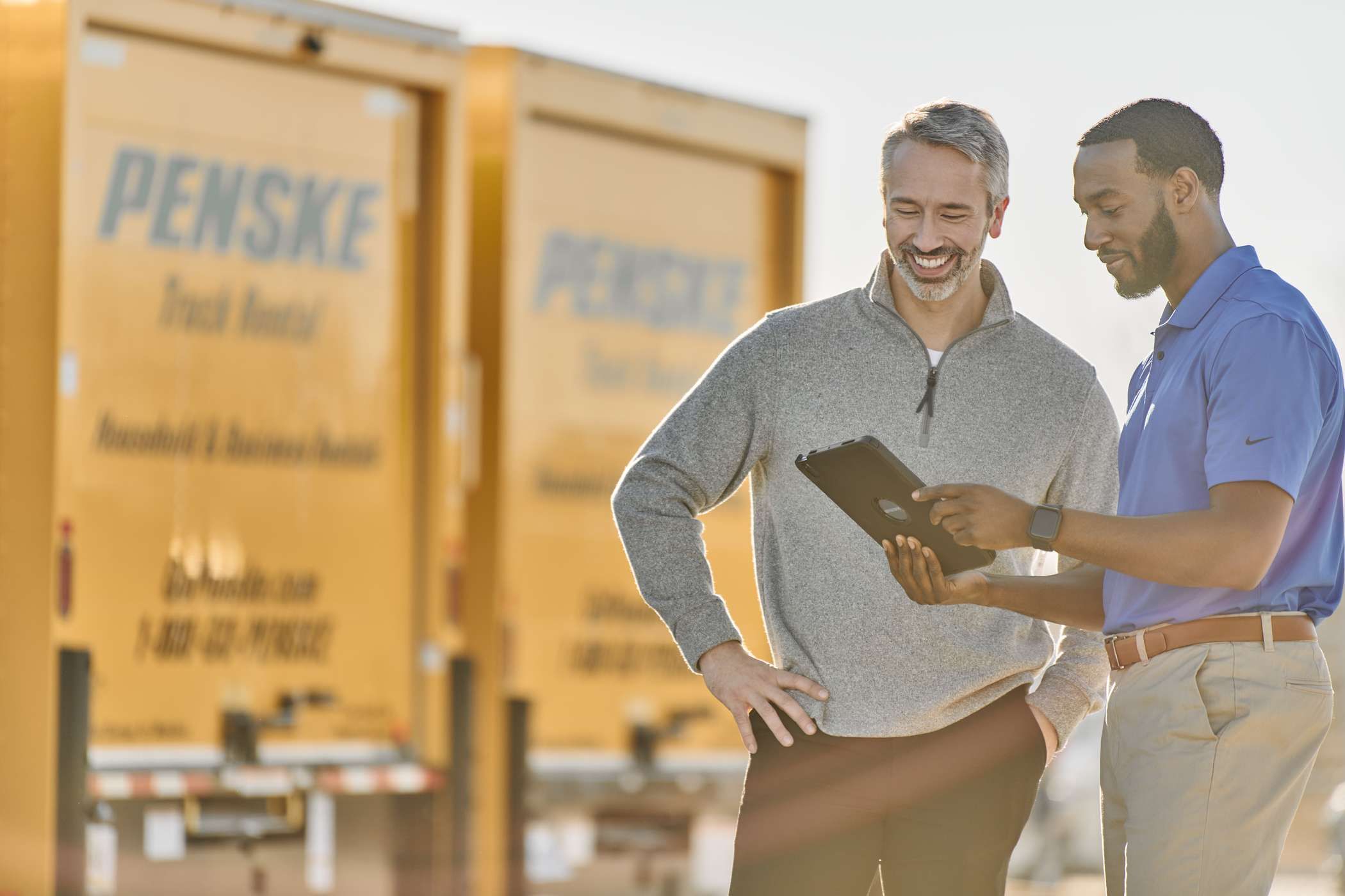 Penske associate discussing a truck rental with a customer