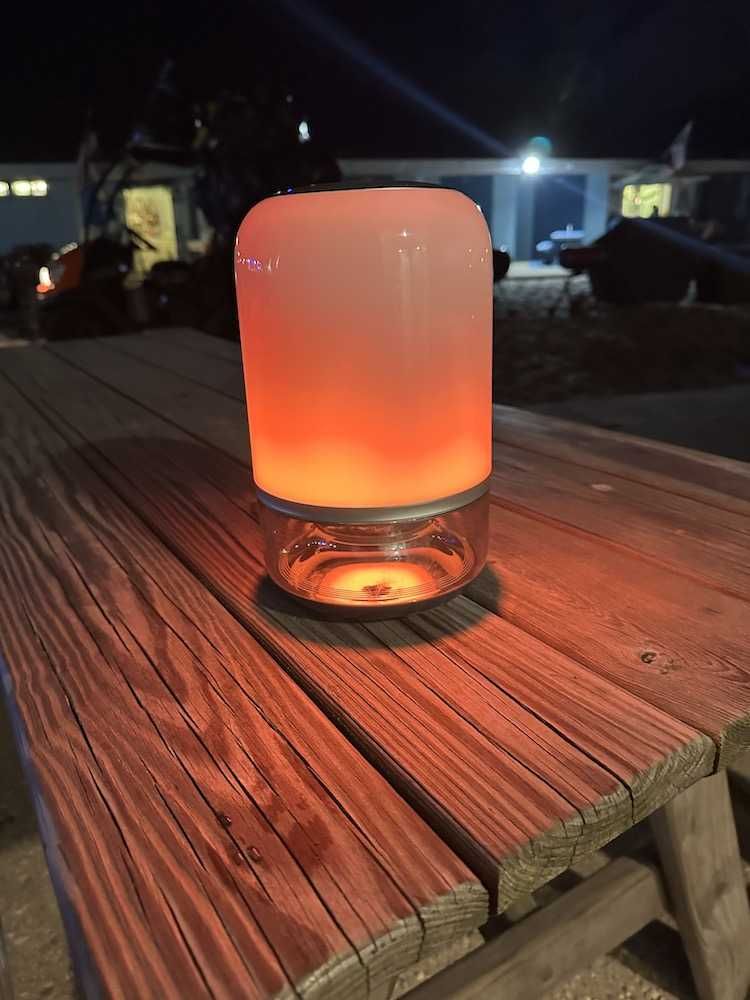a photo of Govee Table Lamp 2 Pro on a picnic table at night at the beach.