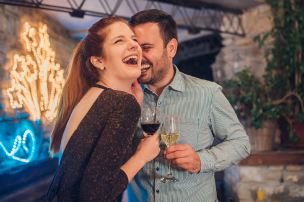 man luaghing, woman laughing, laughing on date, wine, happy couple