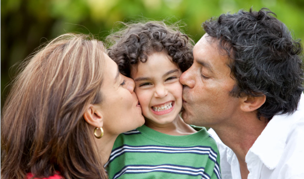 mom, dad, kissing kid, smiling kid, kid and parents, parenting