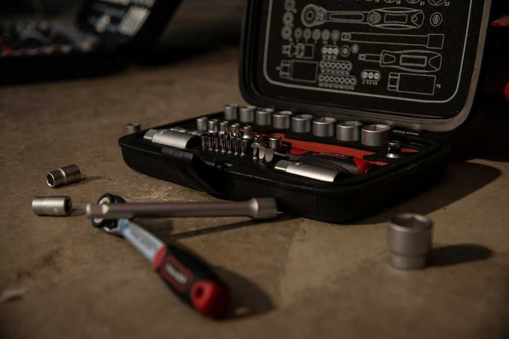 a tool kit with tools in it sitting on a table
