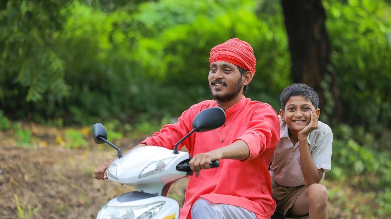 a photo of a man and boy riding a scooter