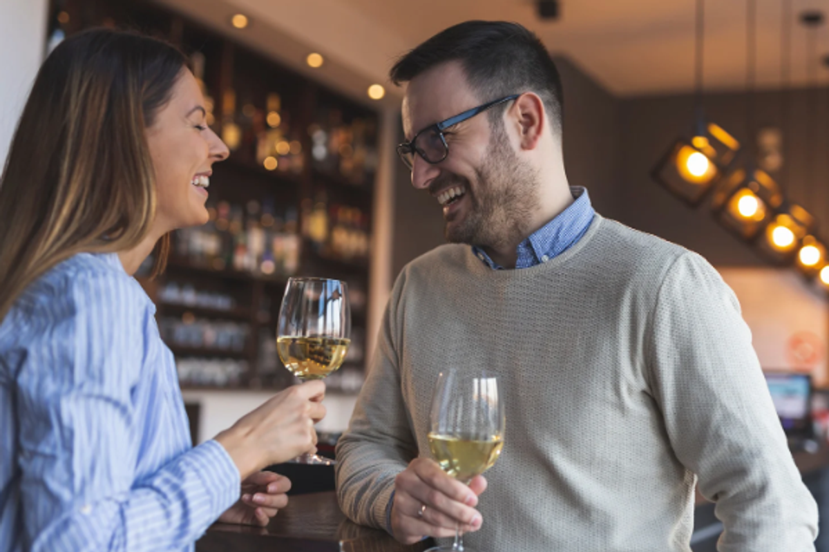 conversation, couple talking, white wine, laughing man, laughing woman,