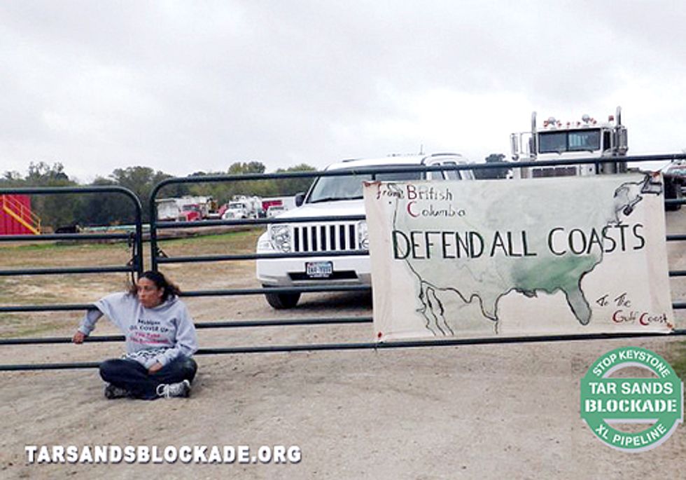 Wife of Gulf Coast Oilfield Worker Chains Herself to Keystone XL Pipeyard Gate