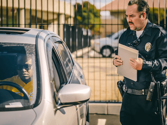photo of a cop speaking to a driver in a car