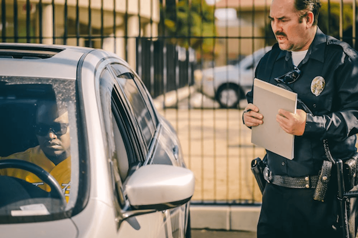 photo of a cop speaking to a driver in a car