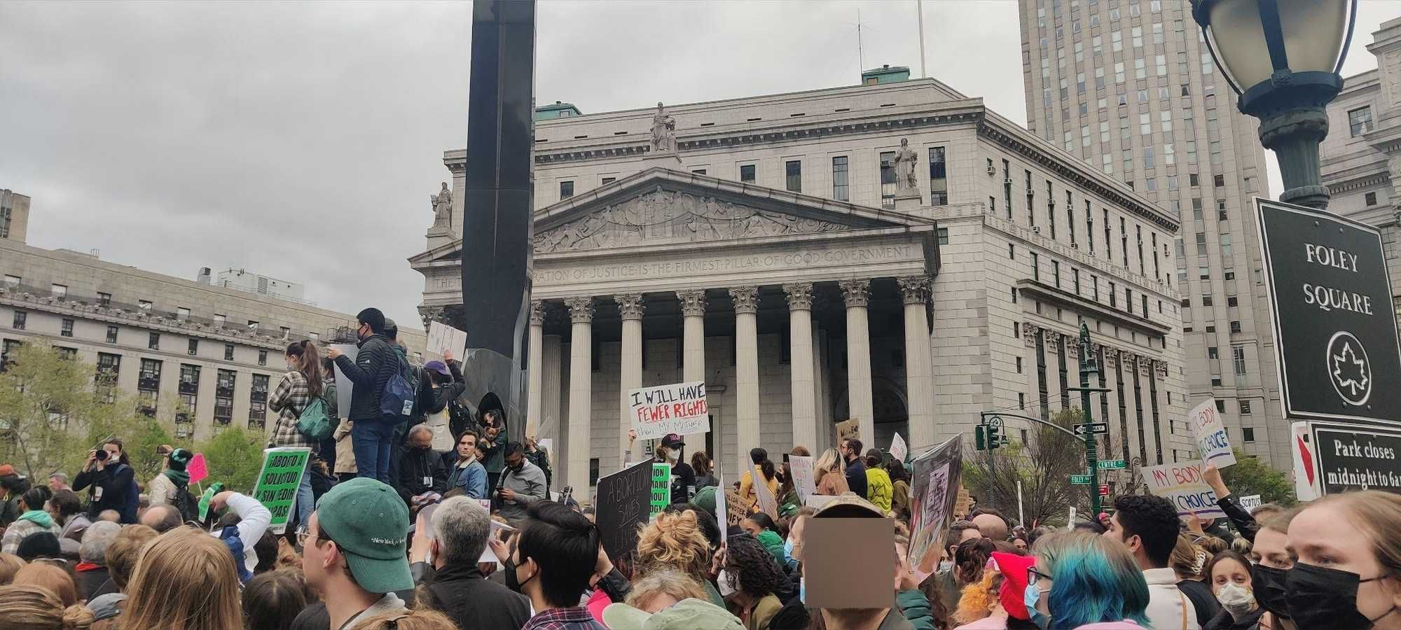 A crowd of abortion rights protesters holding signs in Foley Square in New York City