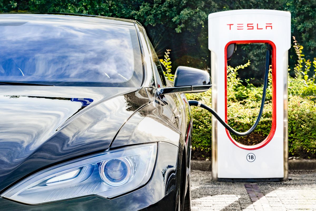 Tesla at its charging station