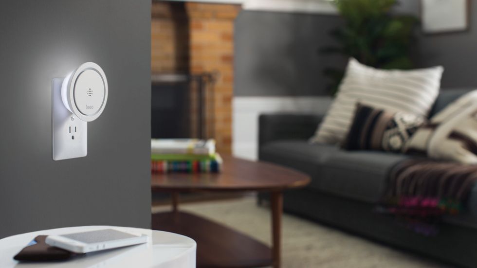a photo of a Leeo smart siren plugged into a wall outlet