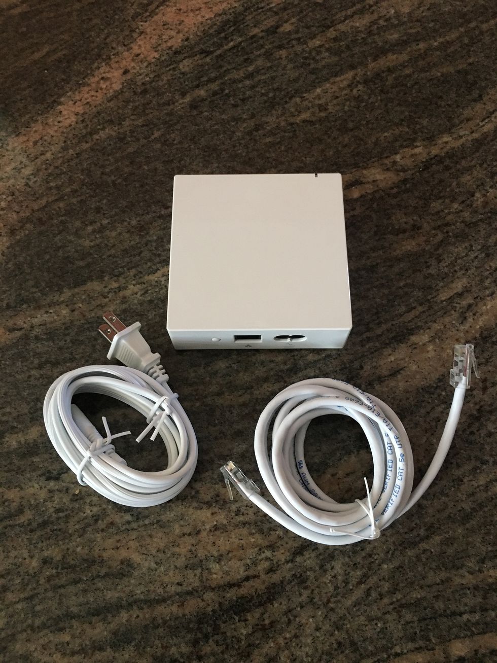 A\u00a0photo of Insteon smart hub and power cords
