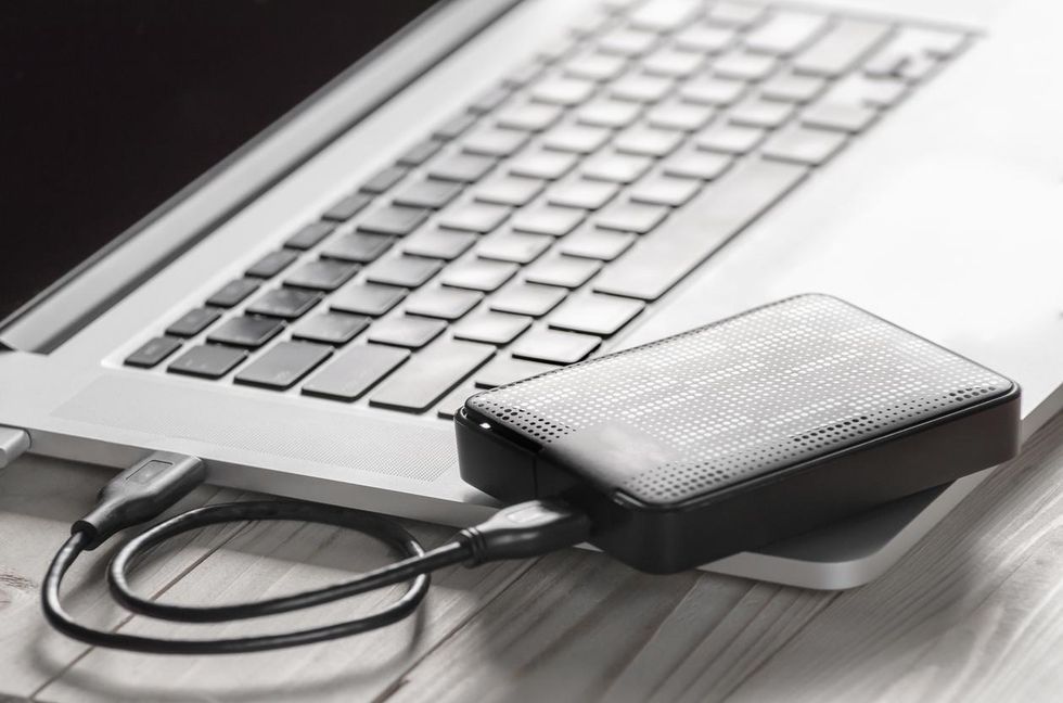 a photo of a portable hard drive connected to a laptop