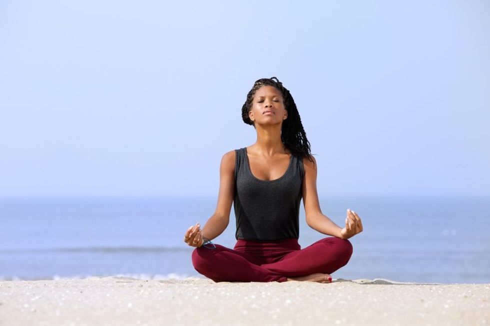 Self-care-practices-woman-meditating-on-the-beach