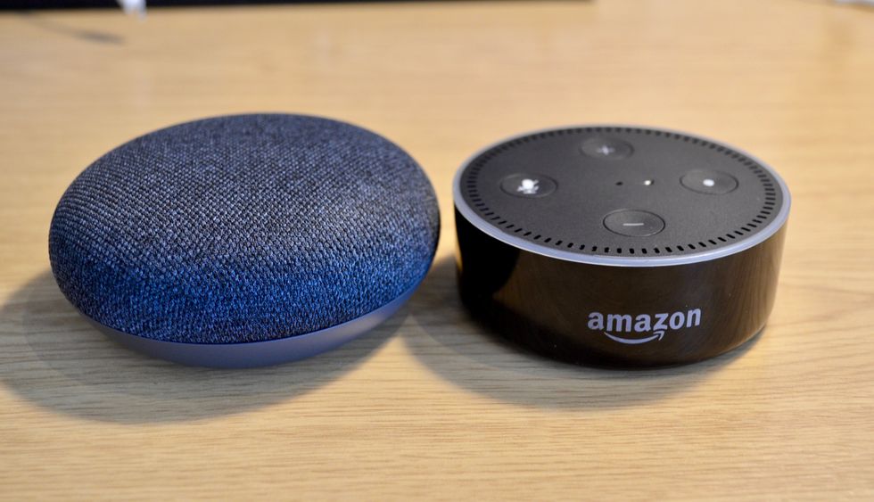 Picture of Google Home Mini next to Echo Dot.