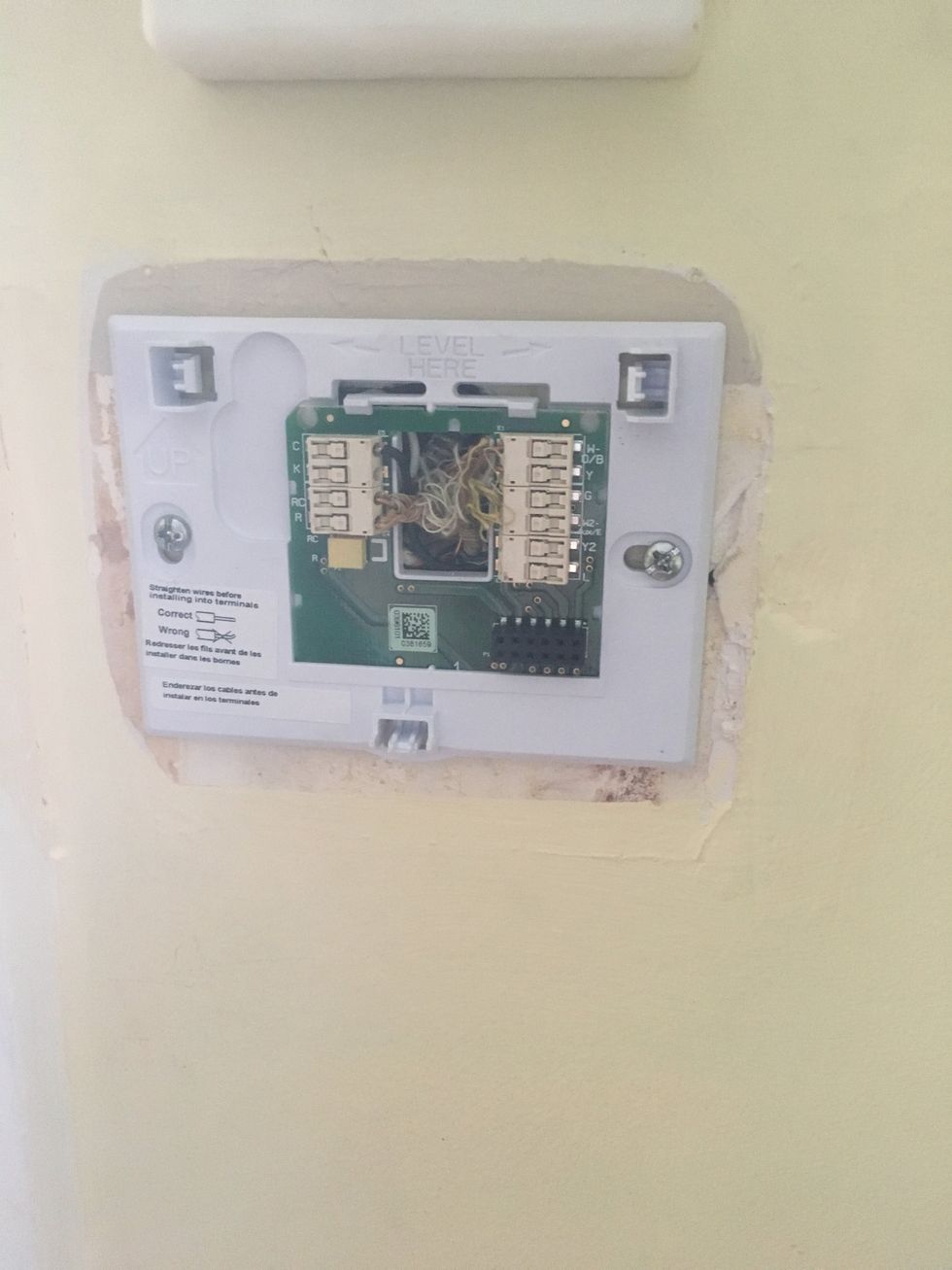the base for honeywell wifi thermostat installed on a wall