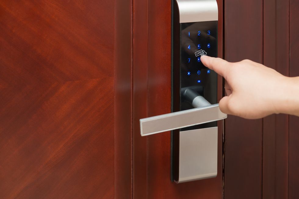 a person unlocking a smart lock with their finger.