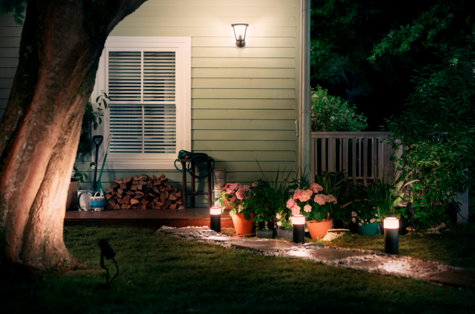 a photo of a backyard with Philips Hue lights at nightime
