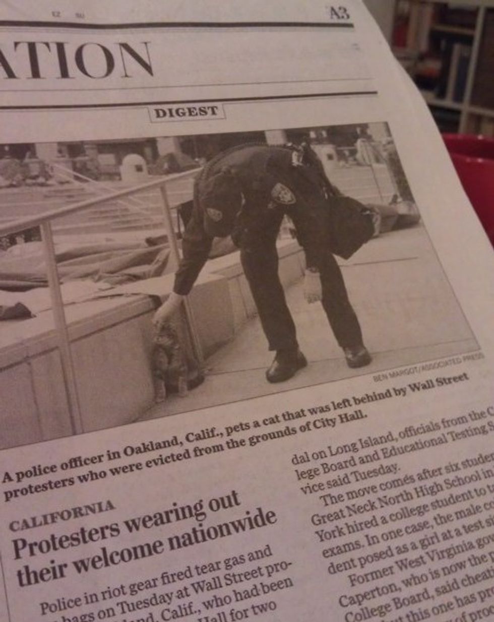 Washington Post Illustrates Oakland Police Brutality With Cop Petting Kitty