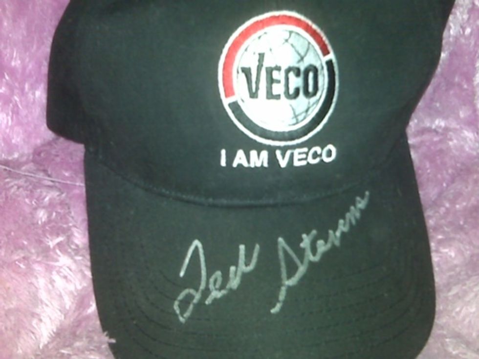 Ted Stevens Signs Ironic Hat, Appears Foolish