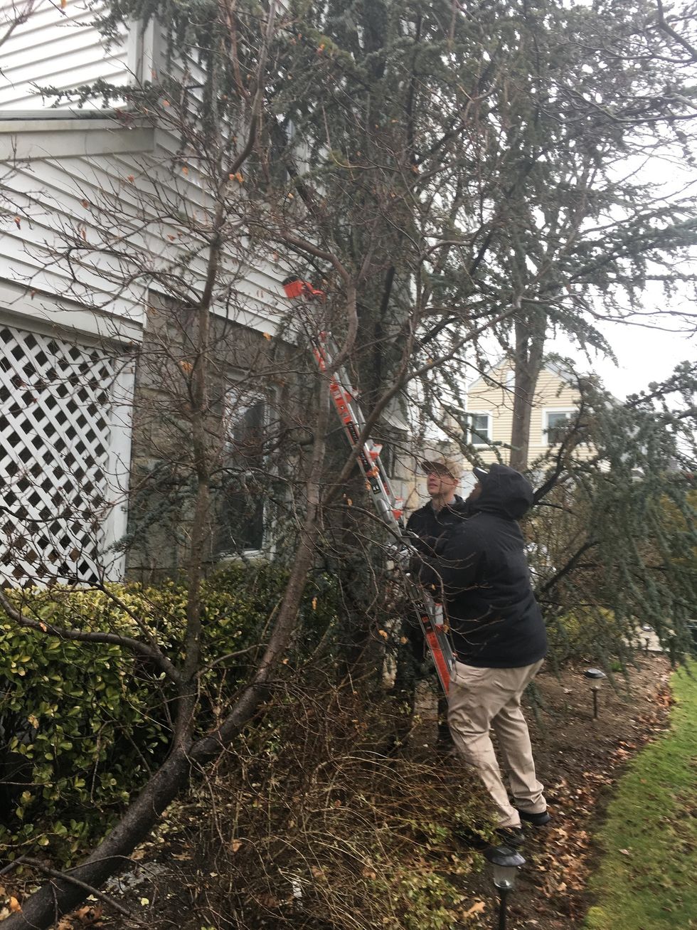 Vivint Installer installing outdoor security camera using PLCs.