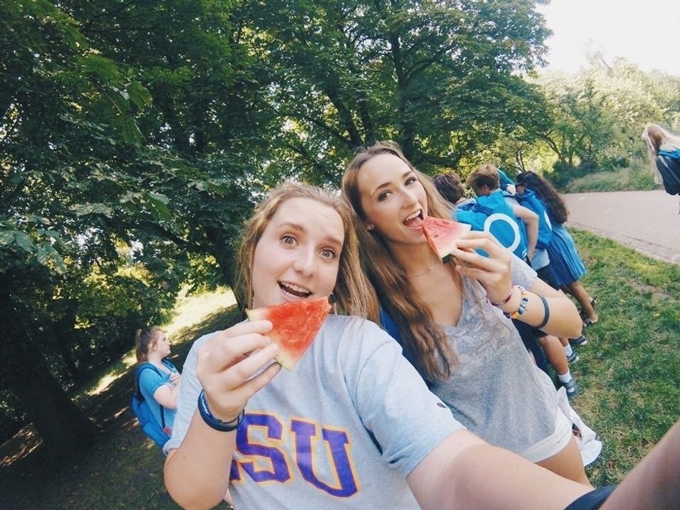 two women LSU students eating watermelon in baton rouge