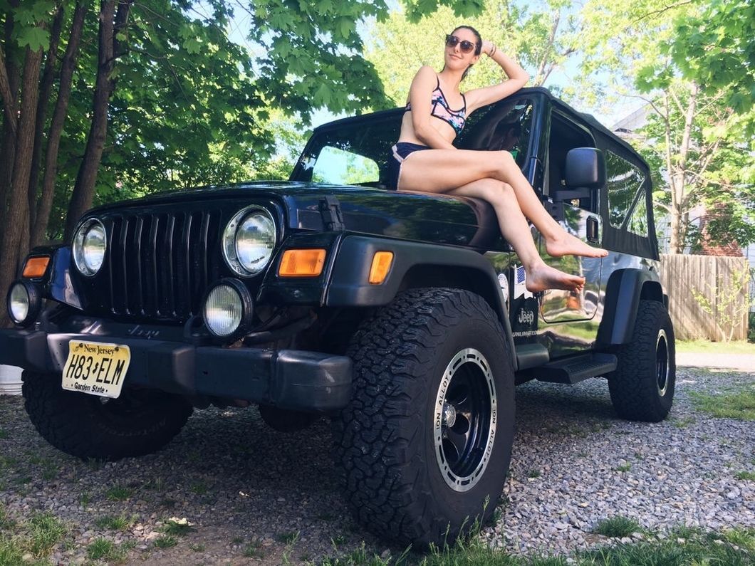 girl sitting on a jeep