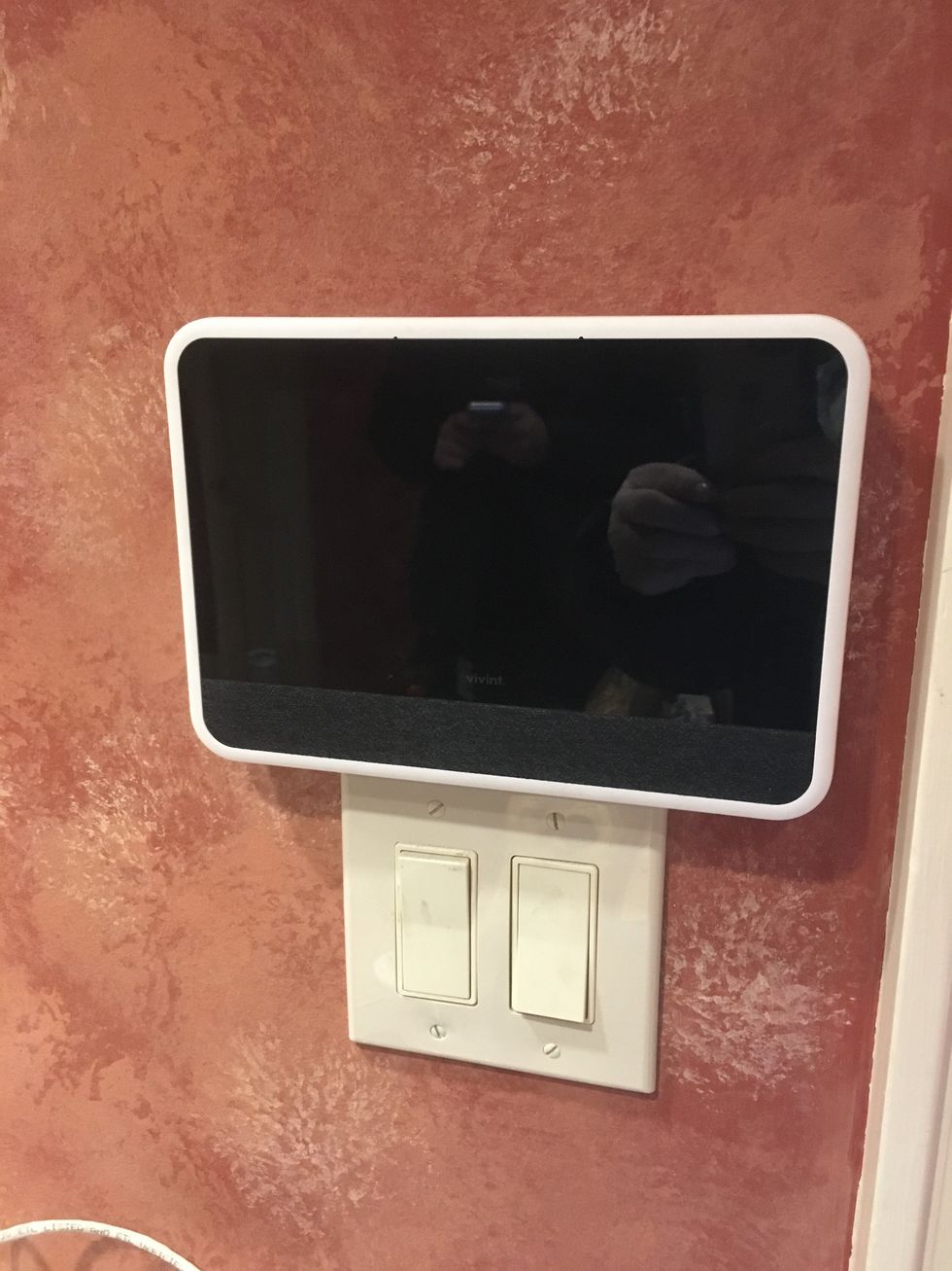 A photo of a Vivint smart home controller on a wall