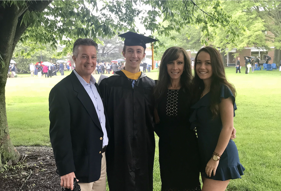 family posing for son's graduation photo