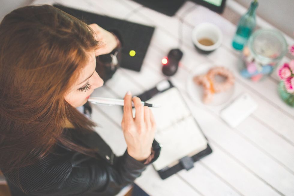 https://www.pexels.com/photo/young-woman-thinking-with-pen-while-working-studying-at-her-desk-6384/