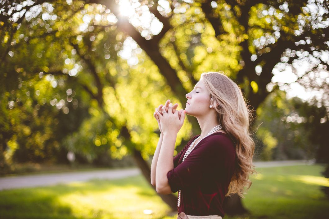 Girl closing her eyes and praying