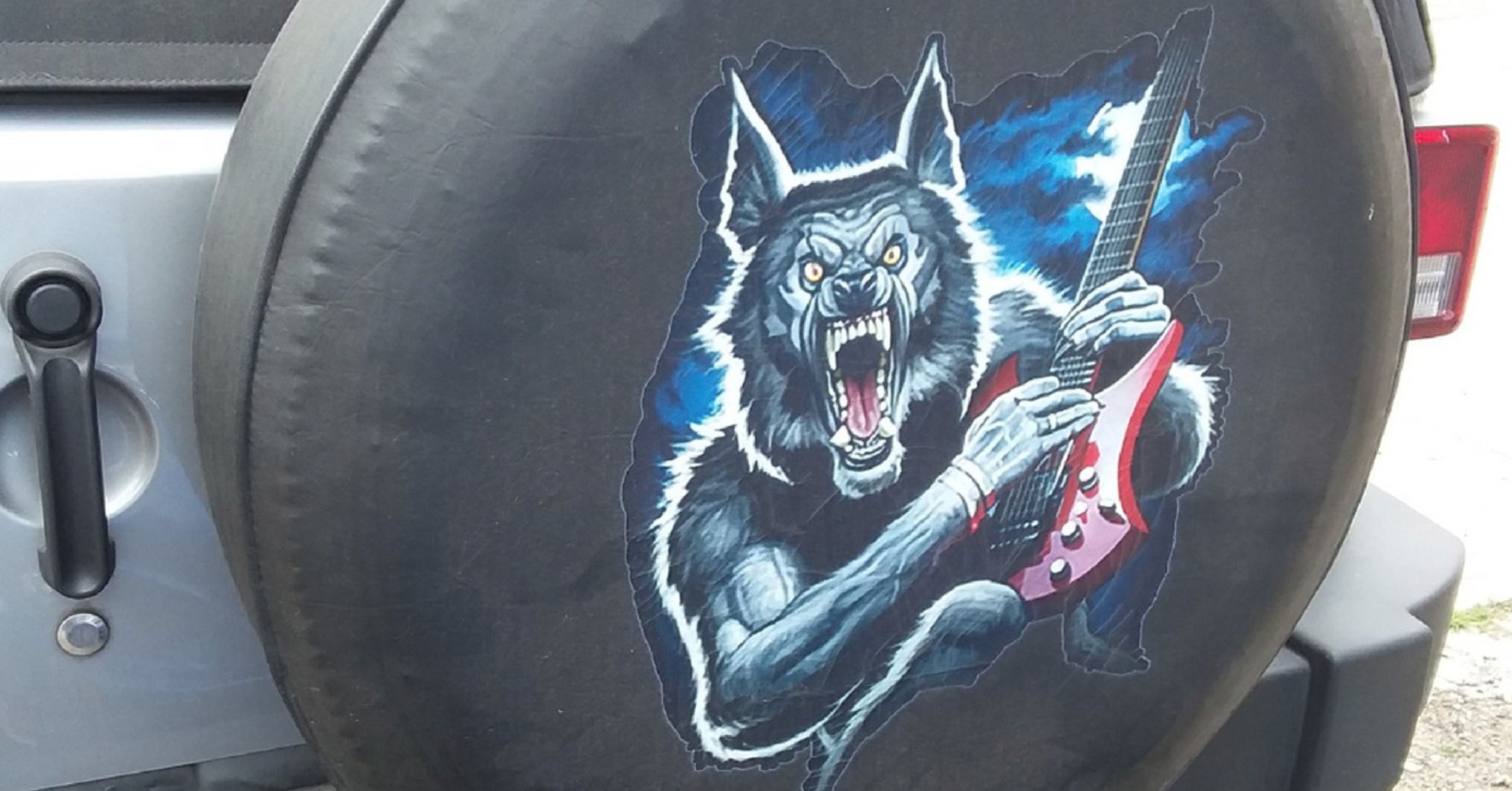 This Bizarre Decal Of A Wolf Playing A Guitar Gets Even Better Upon Closer Inspection 😂