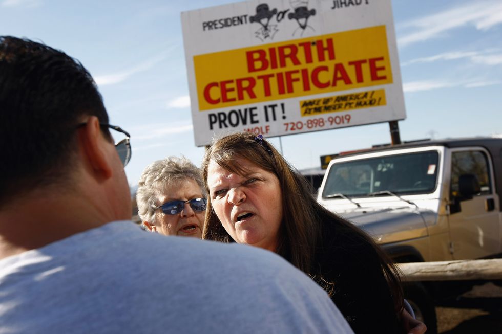 Argument in front of birther billboard.