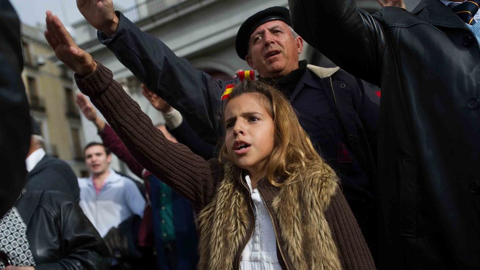 A young girl gives the fascist salute during the 39th anniversary of the death of Spanish dictator General Francisco Franco at Plaza Oriente square on November 23, 2014 in Madrid, Spain. (Denis Doyle/Getty Images)